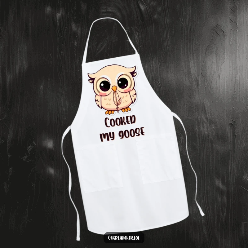 Funny Kawaii owl apron showing a cute owl intently staring at a feather, ideal for kitchen humor and protection.