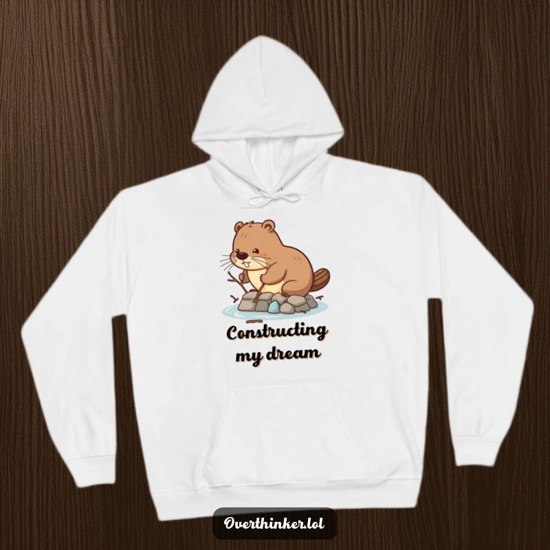 Funny hoodie with a beaver attempting dam construction with tiny twigs, offering warmth and a symbol of dedication.