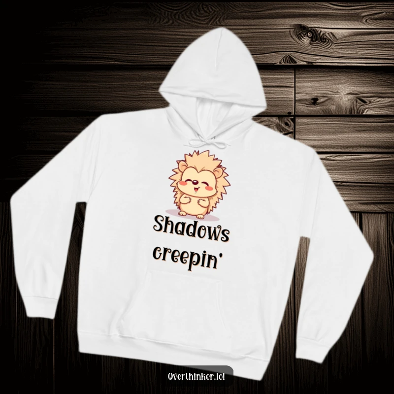 Funny and cozy hoodie featuring a cheerful hedgehog looking worriedly at its shadow.