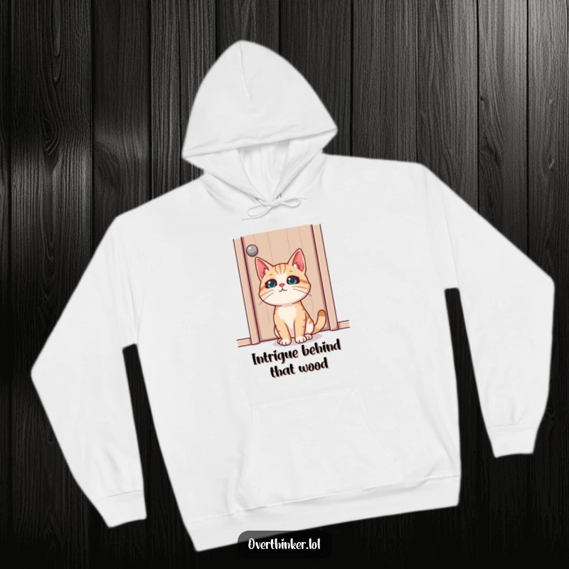 Funny hoodie showing a cat with an expression of deep concentration staring fixedly at a closed wooden door, full of suspense.