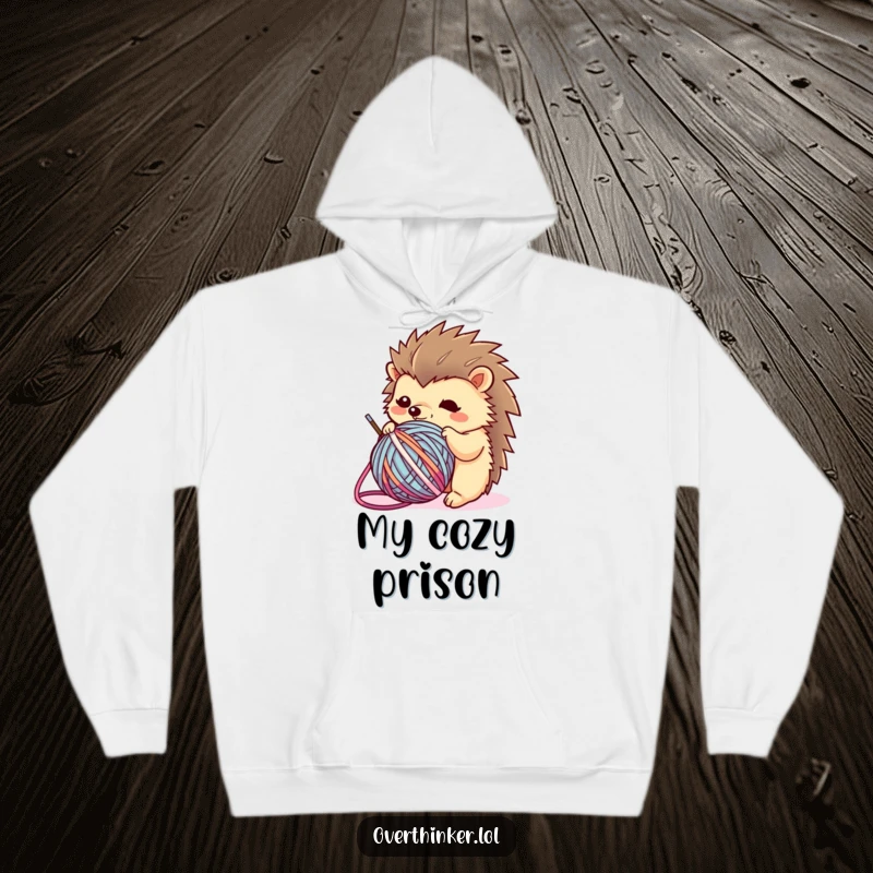 Funny Kawaii hedgehog hoodie featuring a flustered character ensnared by a ball of yarn, offering comfort and a humorous nod to crafting.