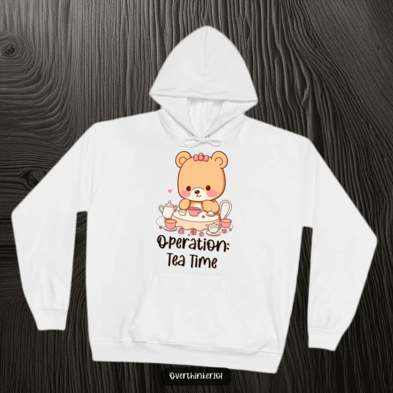 Funny Kawaii bear hoodie featuring a character meticulously planning a tea party, offering comfort and a humorous nod to organizational skills.