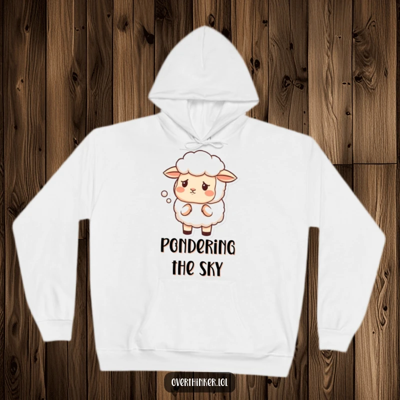 Funny hoodie depicting a sheep with a furrowed brow, contemplating the unusual shape of a cloud.