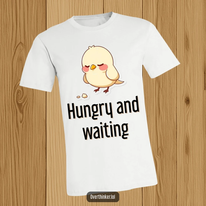 Funny t-shirt with a bird character nervously pecking at one static crumb, symbolizing anxiety and intense, possibly misplaced, focus.